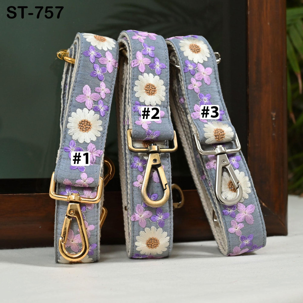 Three floral-patterned straps with numbers 1, 2, and 3 attached, placed on a wooden surface.