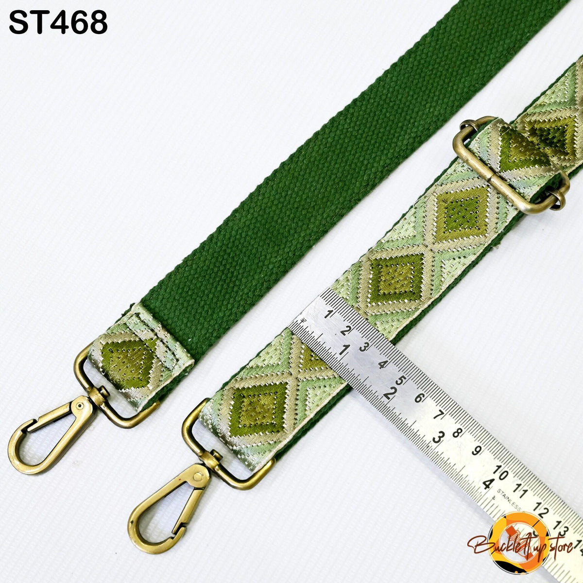 a green strap with a metal ruler placed next to it, indicating the strap's length.