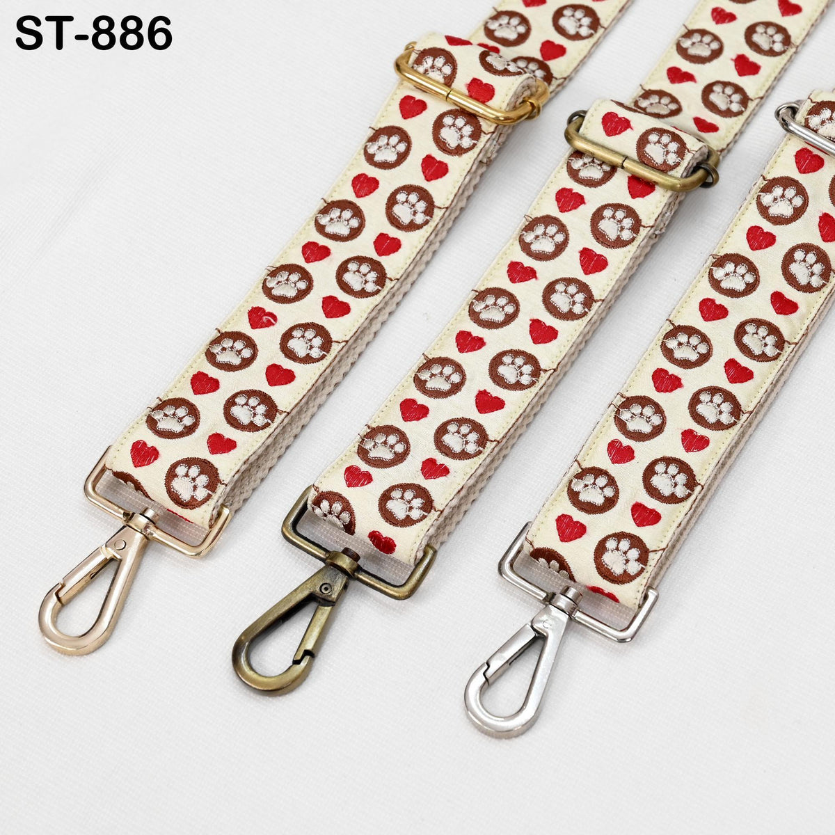 three straps with a pattern of paw prints and hearts on them.