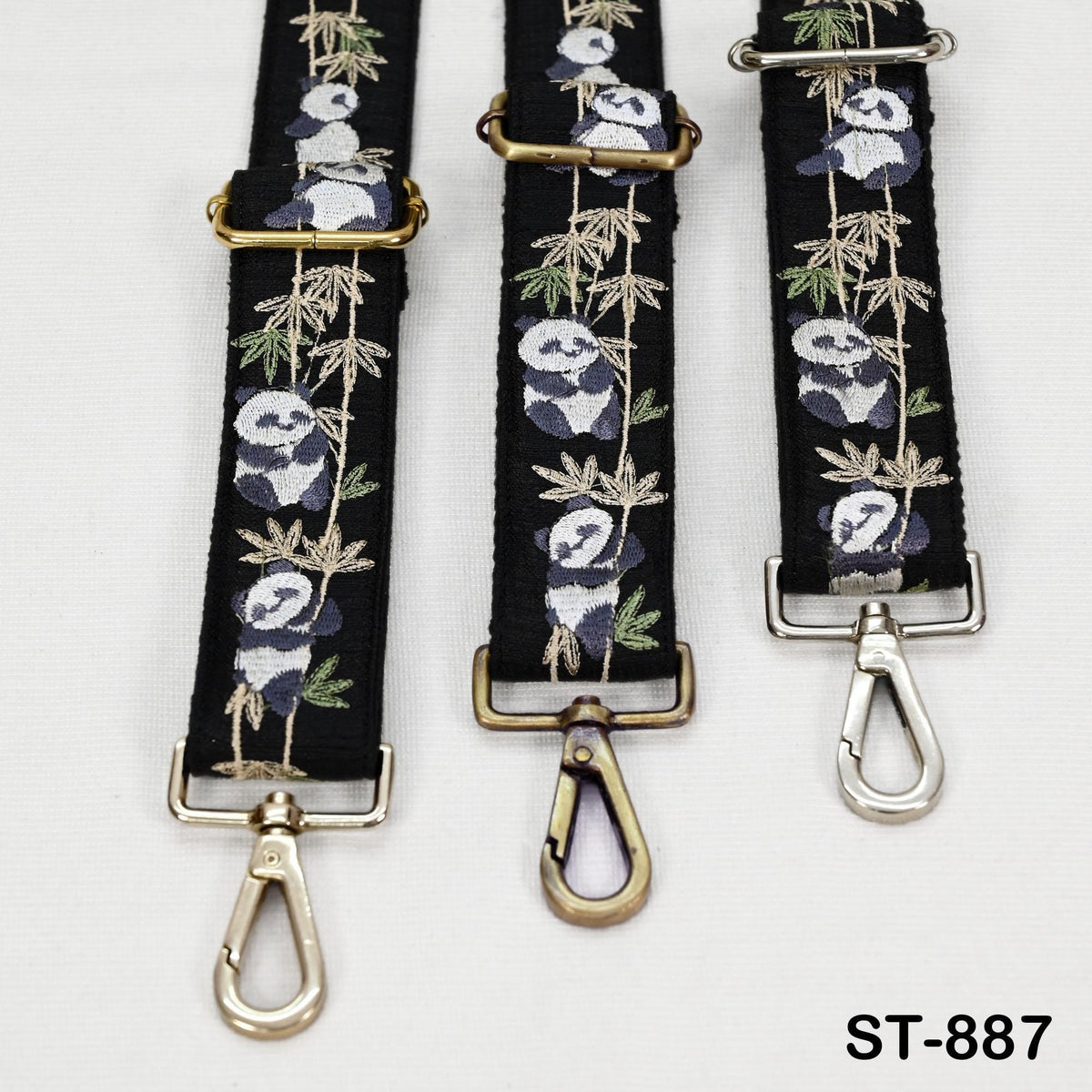 three black straps with panda designs, each featuring a metal clasp and hook.