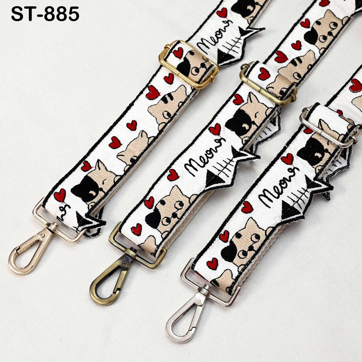a collection of three straps with a cat design, featuring a repeating pattern of cats and hearts. The straps appear to be made of fabric and have metal hooks for attaching them to bags or other accessories.