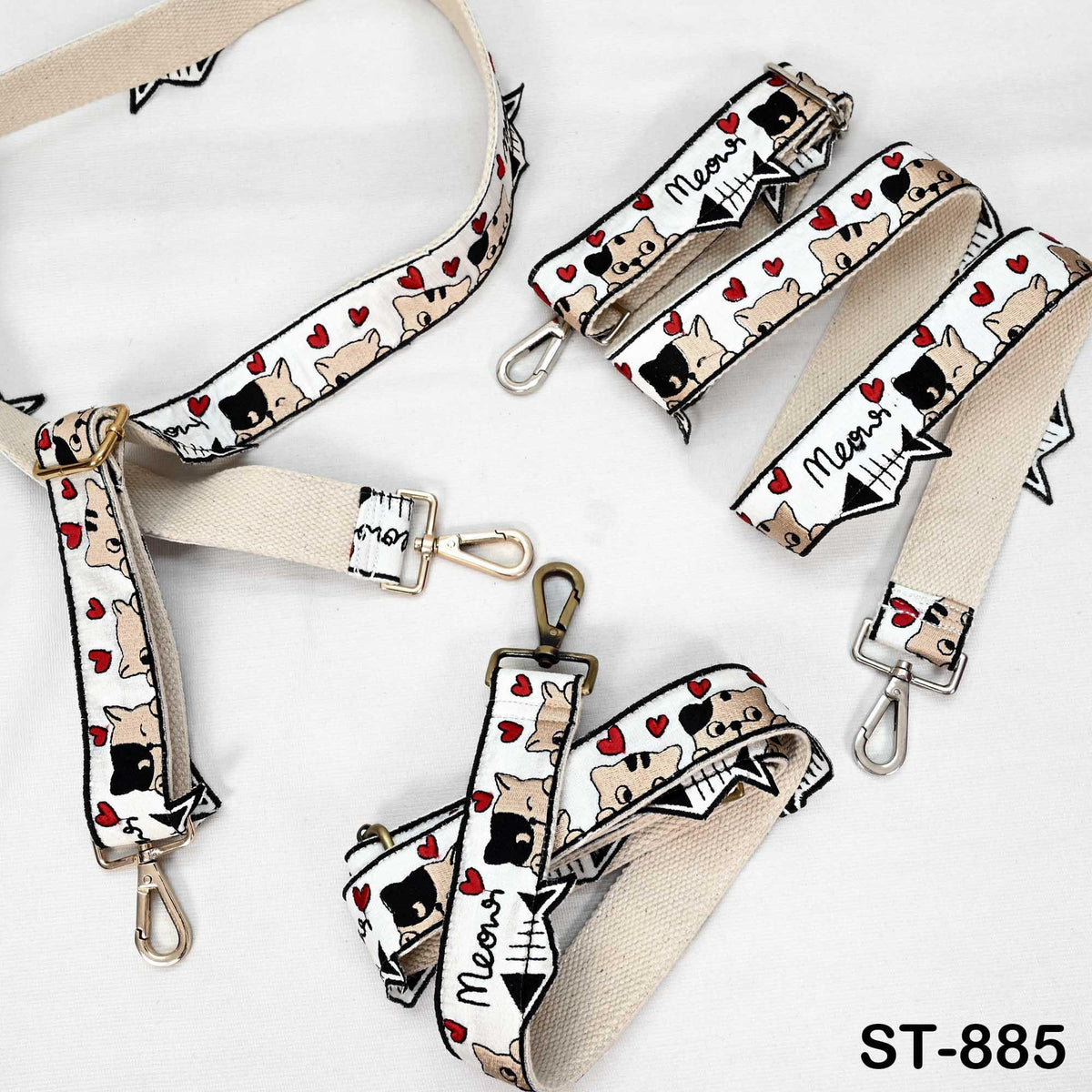 several beige straps with a pattern of cats and hearts, as well as some additional straps with the word "Meows" printed on them.