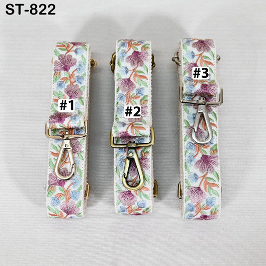 Three floral-patterned straps with metal hooks and buckles, each with a different number printed on it.