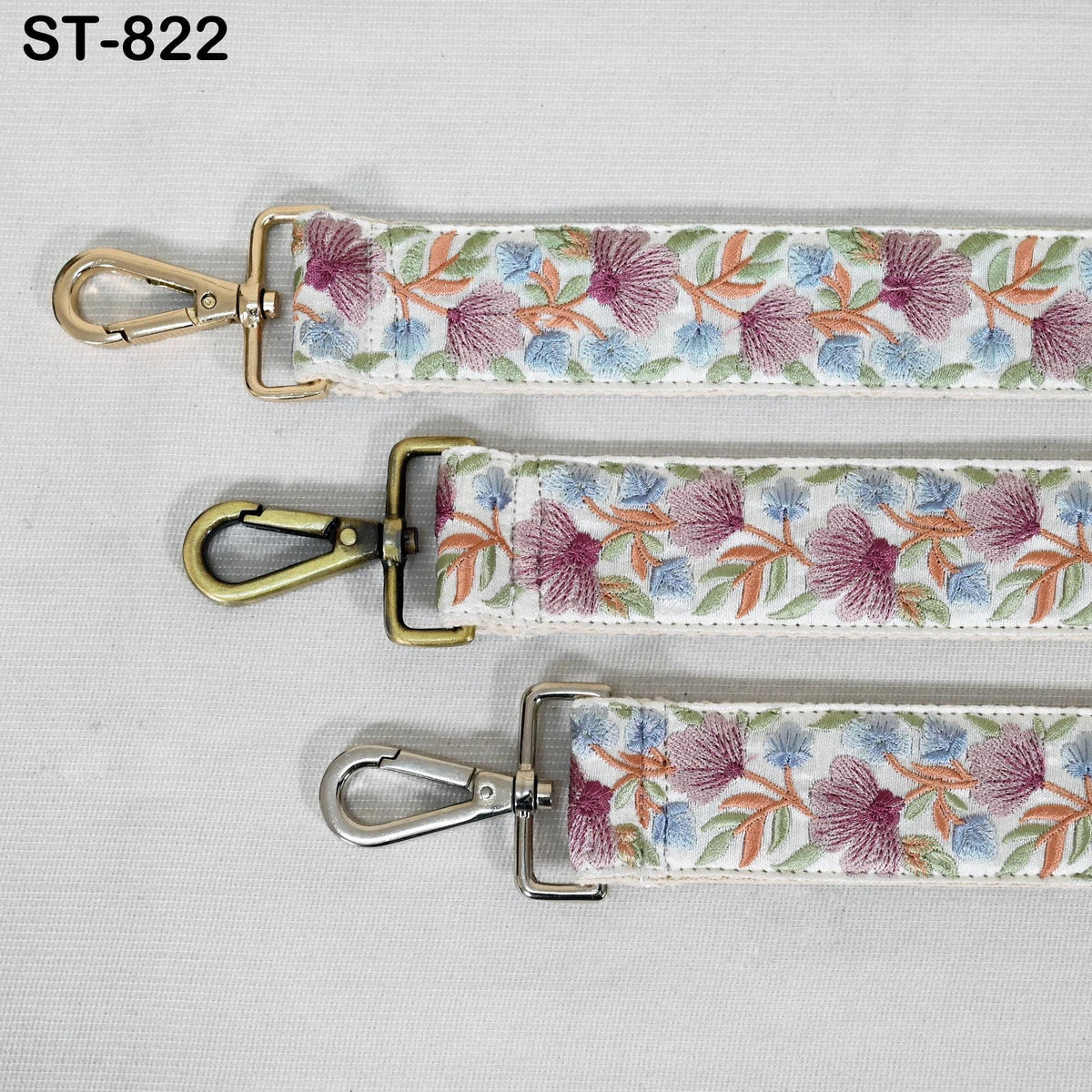 three straps with floral embroidery patterns, each with a metal clasp and hook.