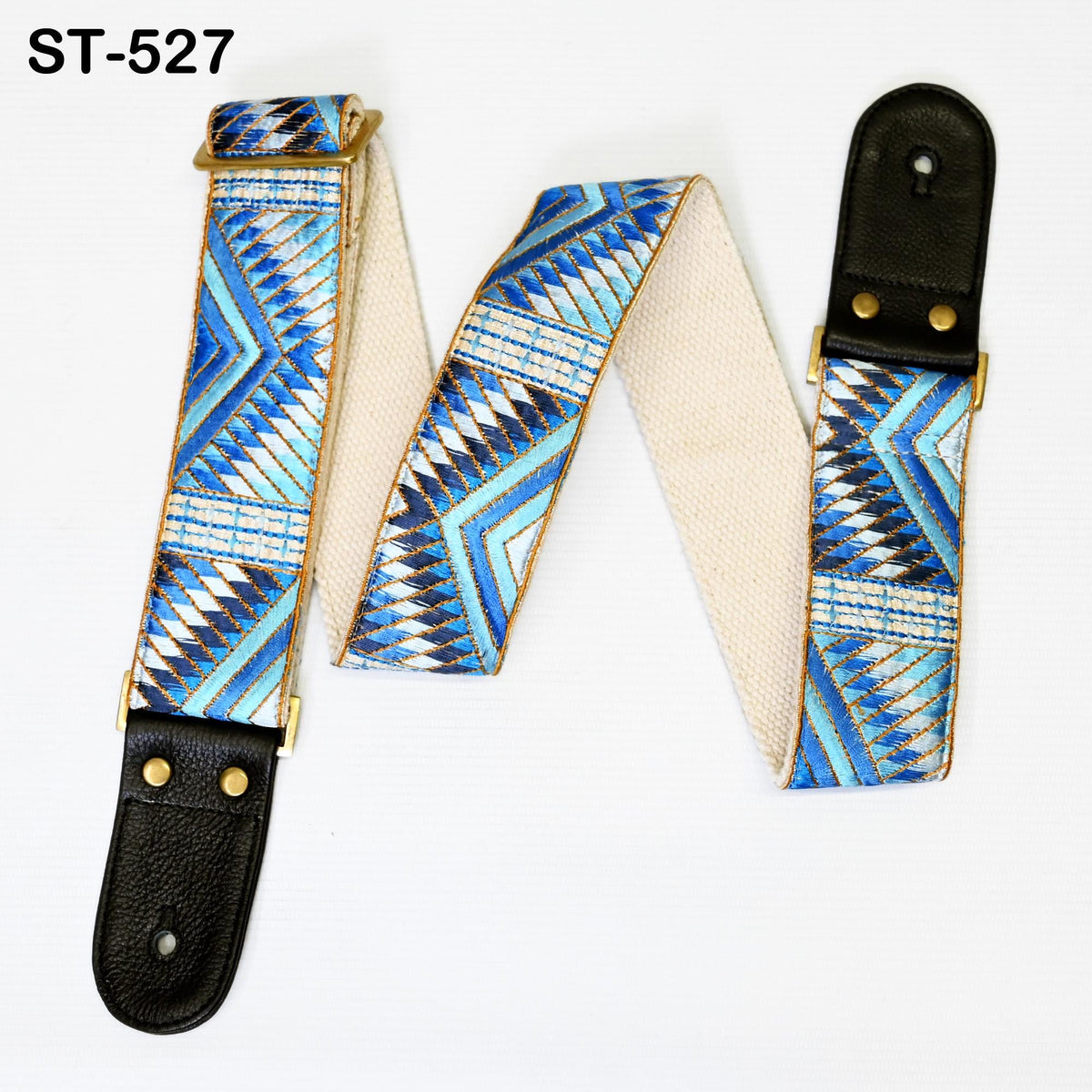 A guitar strap with a geometric pattern in blue and white colors, featuring a black leather buckle.