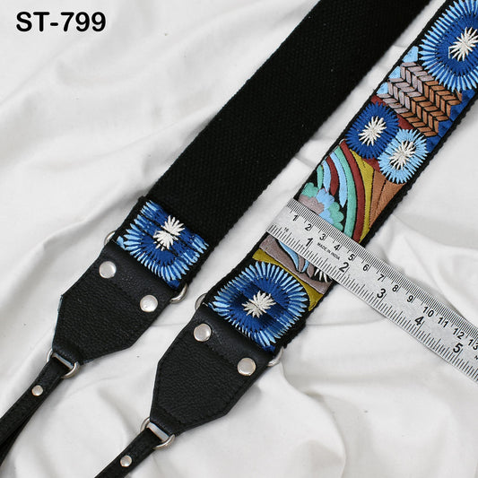 A black strap with a colorful floral embroidered pattern, and a ruler placed next to it, indicating the strap's length.