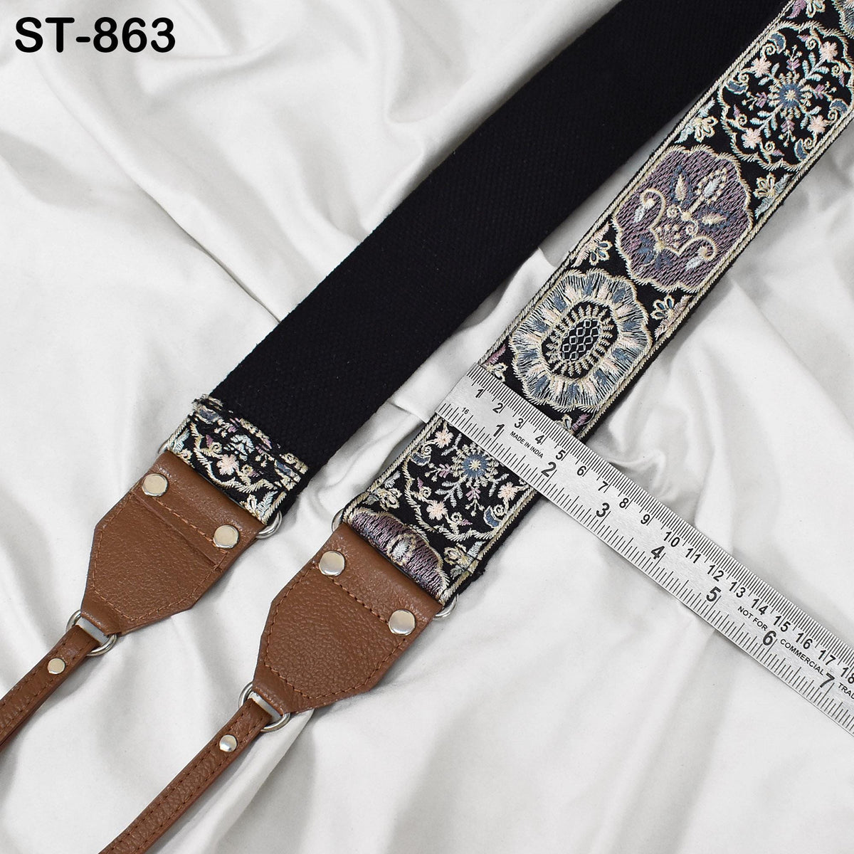 A black and brown patterned strap with a ruler placed next to it, indicating the strap's length.