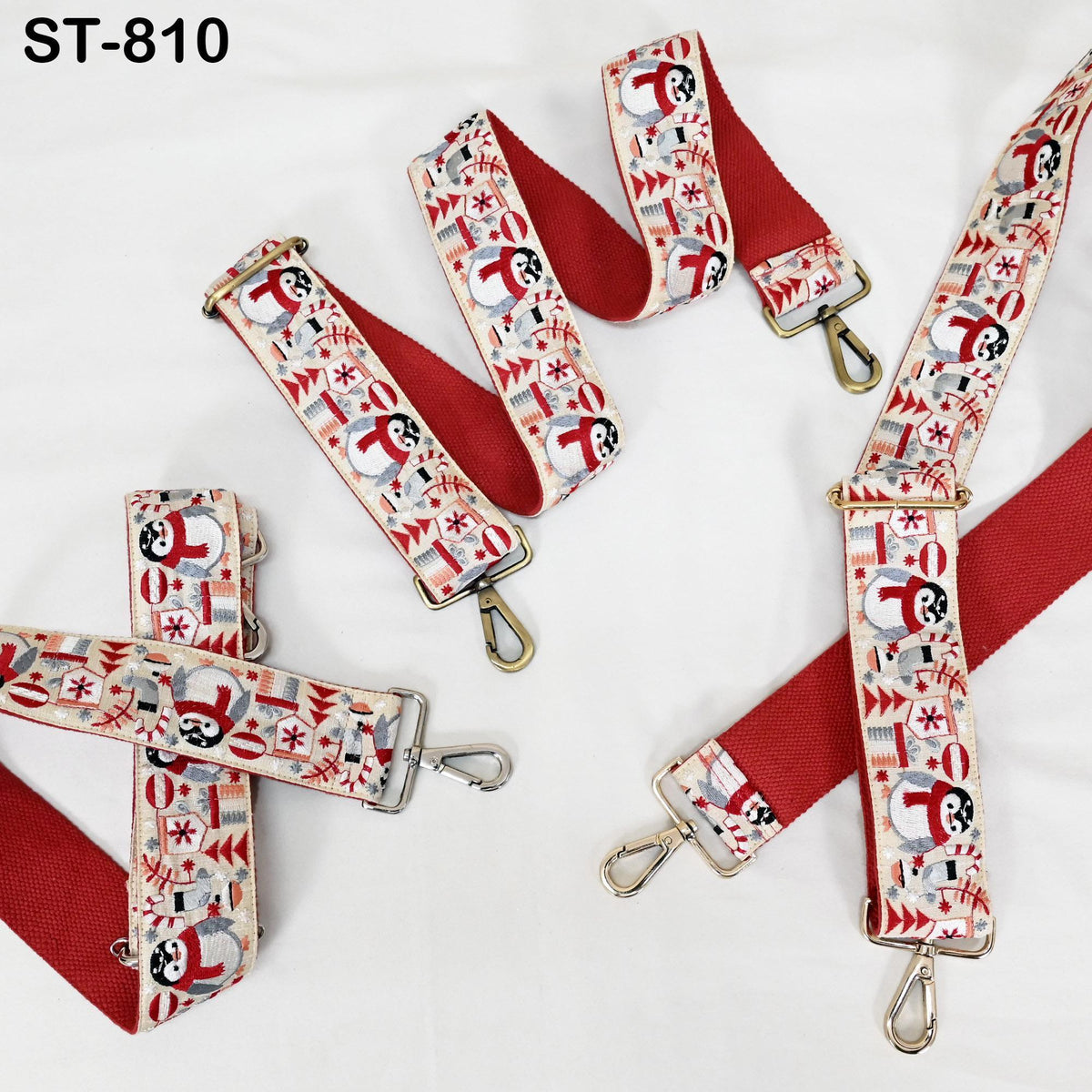 a collection of red and white straps with various patterns, including snowmen and Christmas trees, arranged on a white background.