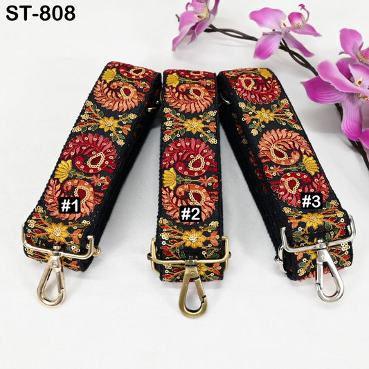 Three colorful straps with floral patterns, each with a metal clasp and hook, are displayed on a white background.