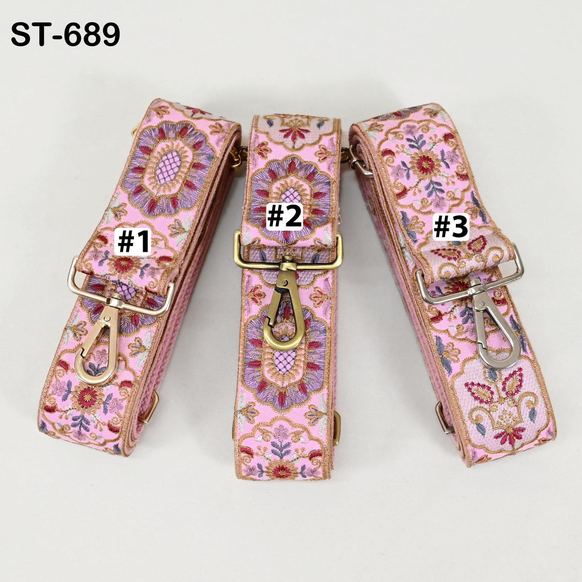 Three pink floral patterned straps with numbers 1, 2, and 3 printed on them, each with a metal clasp and hook.