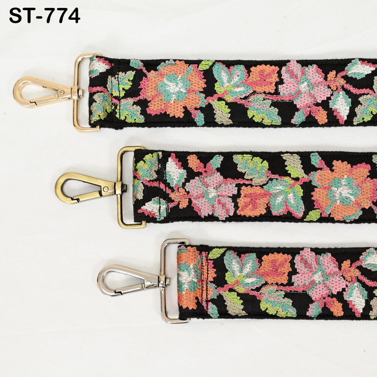 three colorful floral straps with gold metal hardware, arranged in a row.