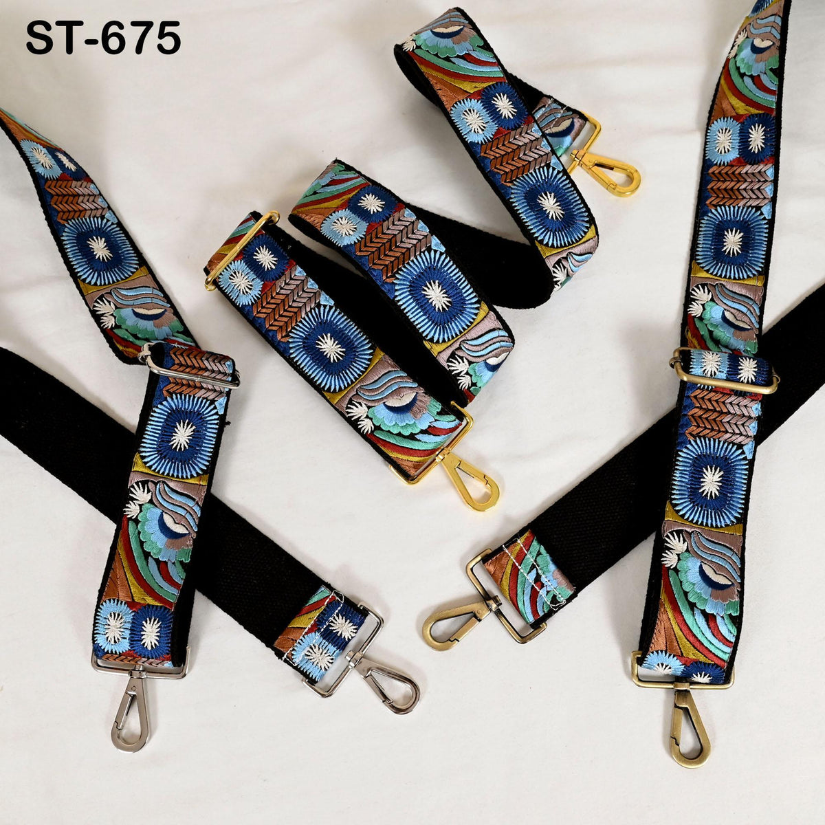 a collection of colorful, patterned straps with metal buckles, arranged on a white background.