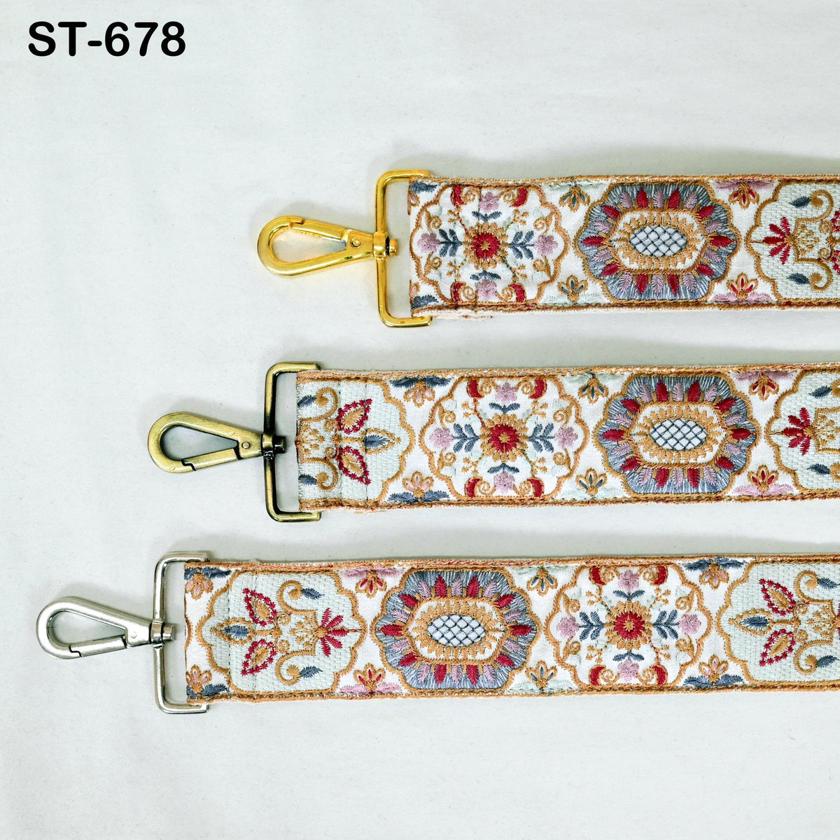 three straps with different designs, including floral patterns and metallic elements.
