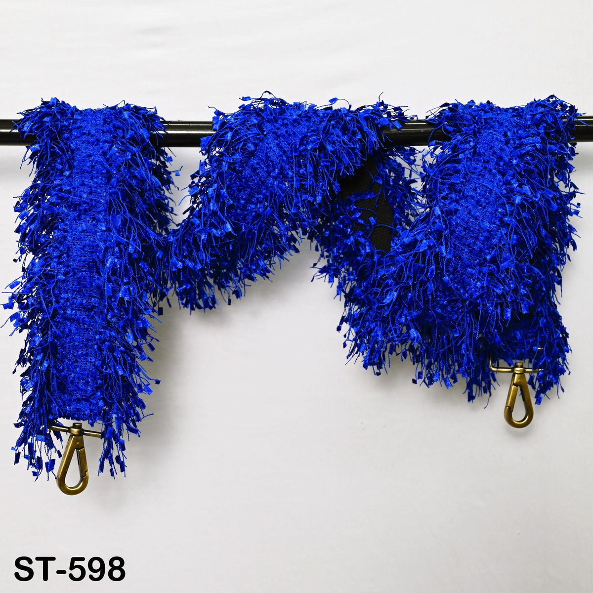 a blue, fuzzy, and textured fabric with a metallic hook attached to it.