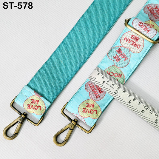 a turquoise strap with a metal clasp and a ruler placed on top of it.
