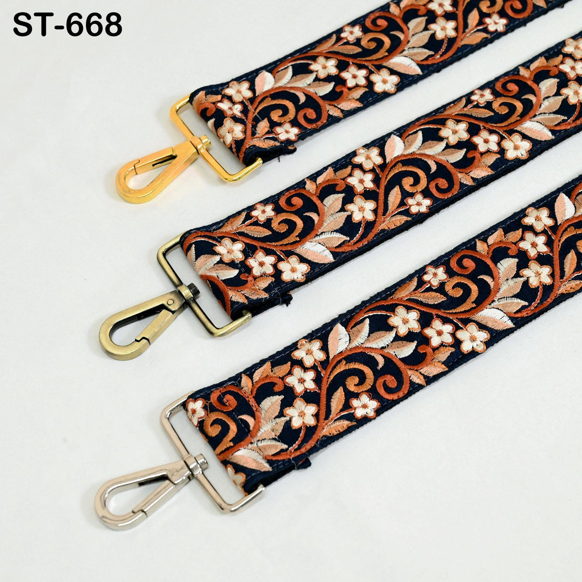 three straps with floral patterns in shades of orange and black, each with a metal clasp and hook.