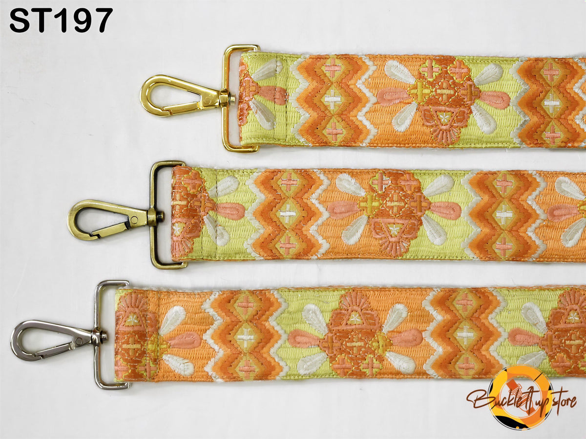 three straps with a floral pattern in shades of orange and yellow. The straps have metal buckles and hooks, and the straps appear to be made of fabric.