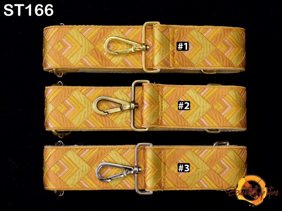 three straps with a geometric pattern in shades of yellow and orange, each with a metal clasp and a small label indicating the number.
