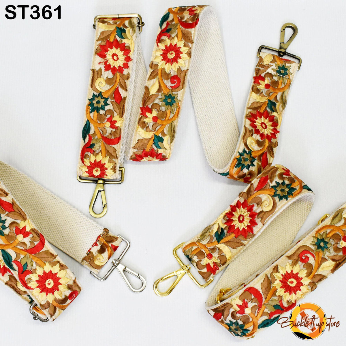 a collection of colorful, floral-patterned straps with gold hardware, including buckles and hooks, arranged on a white background.