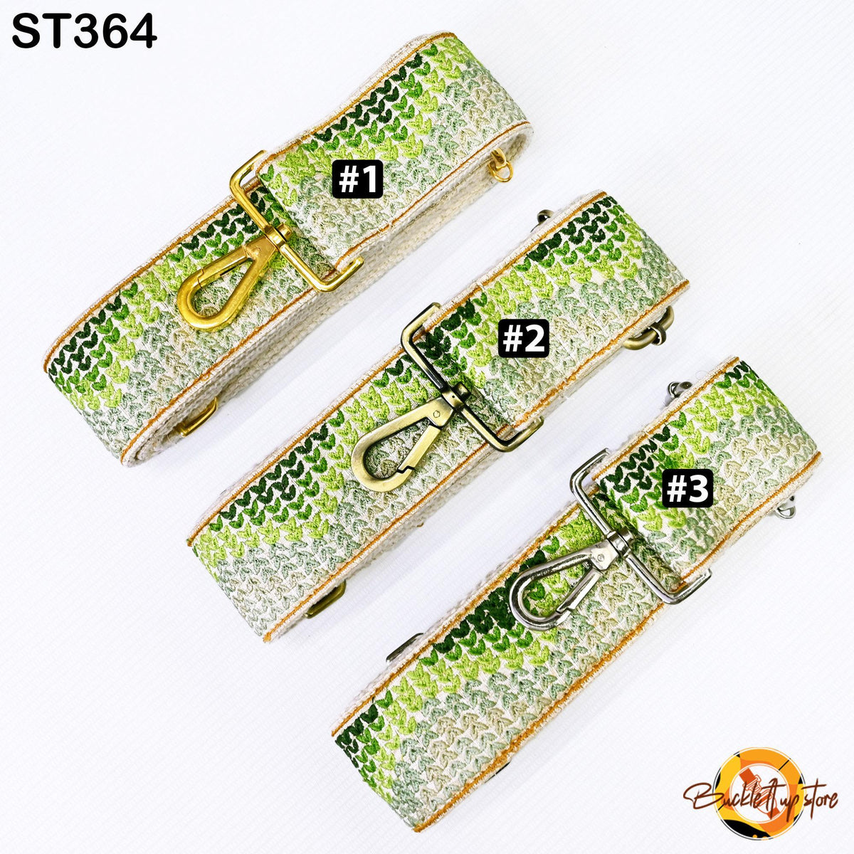 three different straps with a green and white patterned design, each with a gold-colored metal clasp. The straps appear to be adjustable and designed for use with bags or other accessories.