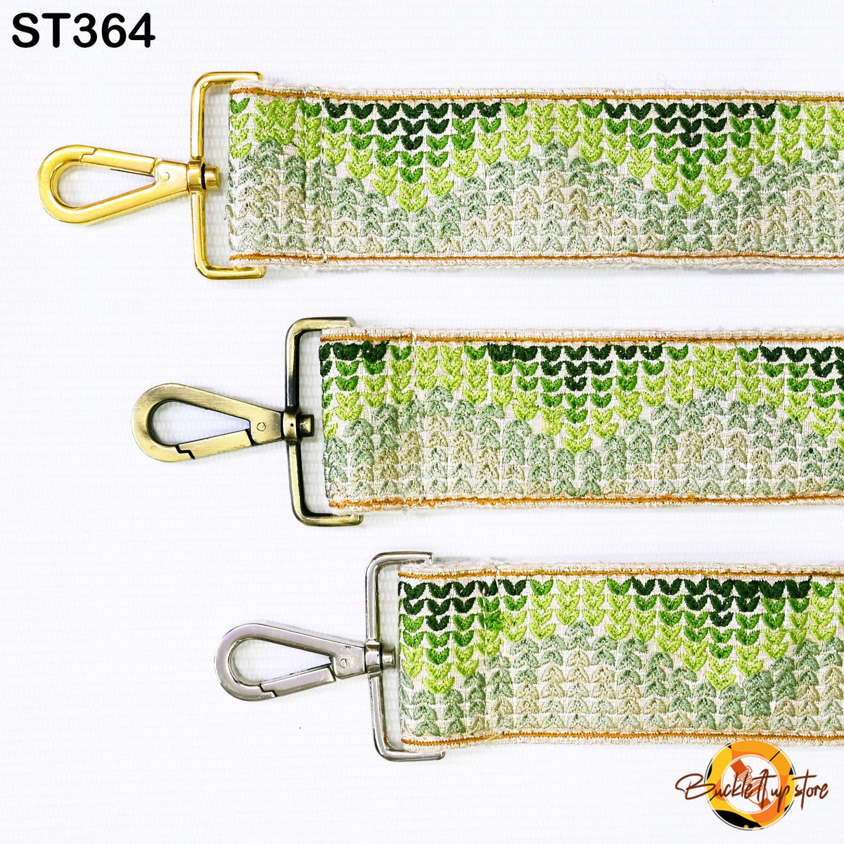 three different straps with a green and white patterned design. The straps appear to be made of a material that resembles fabric or leather, and they have metal hooks or clasps attached to them. The straps are arranged in a row, with the top one being the largest and the bottom one being the smallest.