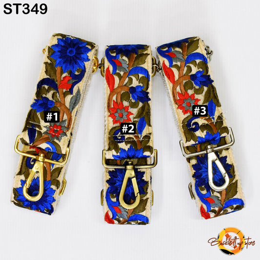 Three colorful straps with floral designs, each with a gold clasp and a small black number on it.