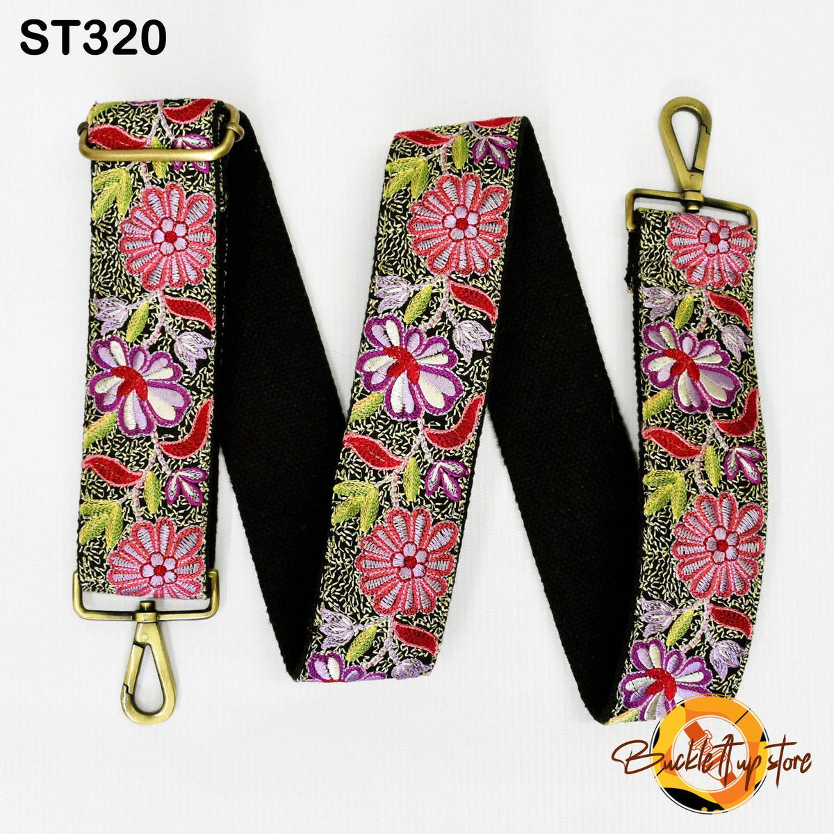 A floral patterned strap with a black background, featuring a gold buckle and a gold-colored metal hook.