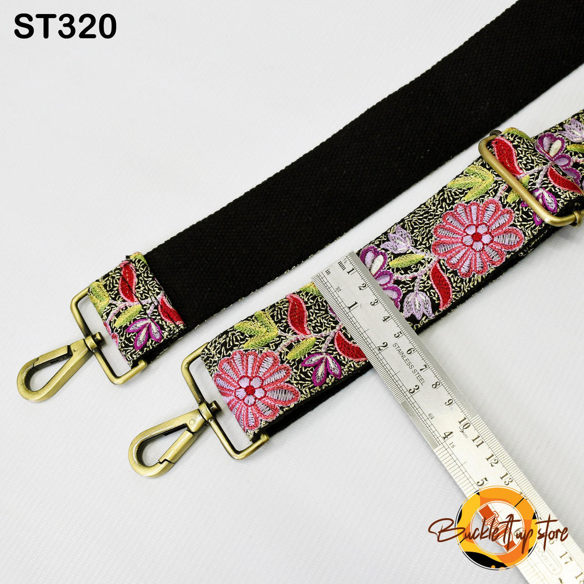 a floral patterned strap with a black strap, a ruler, and a metal clasp.