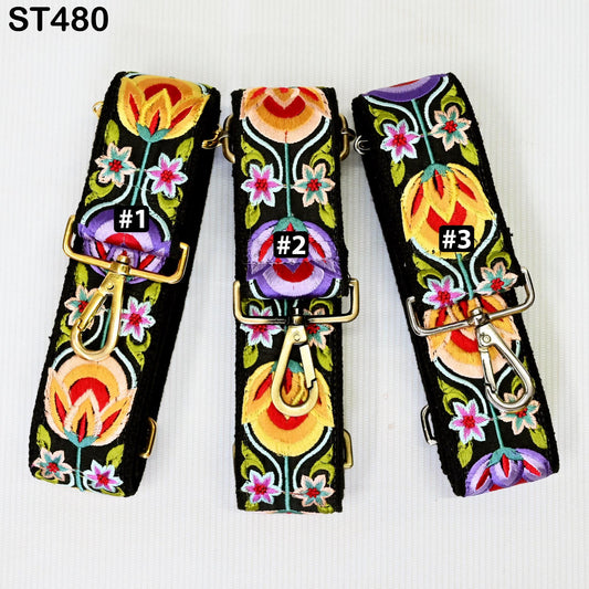 three colorful, floral-patterned straps with gold buckles, arranged side by side.