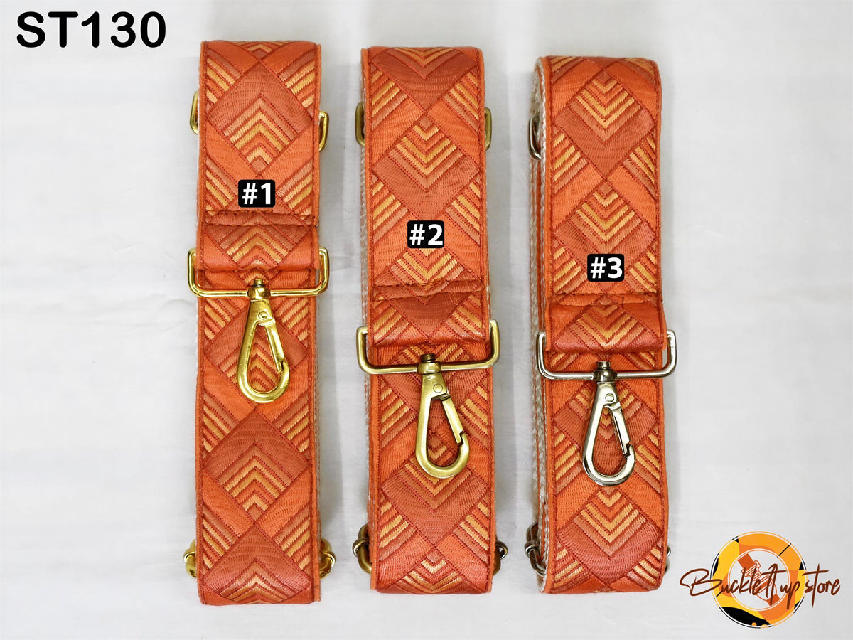 Three orange and gold patterned straps with metal hooks, each labeled with a number.
