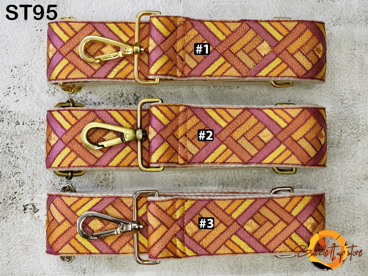 Three colorful straps with gold buckles, each with a unique pattern, are displayed on a white surface.