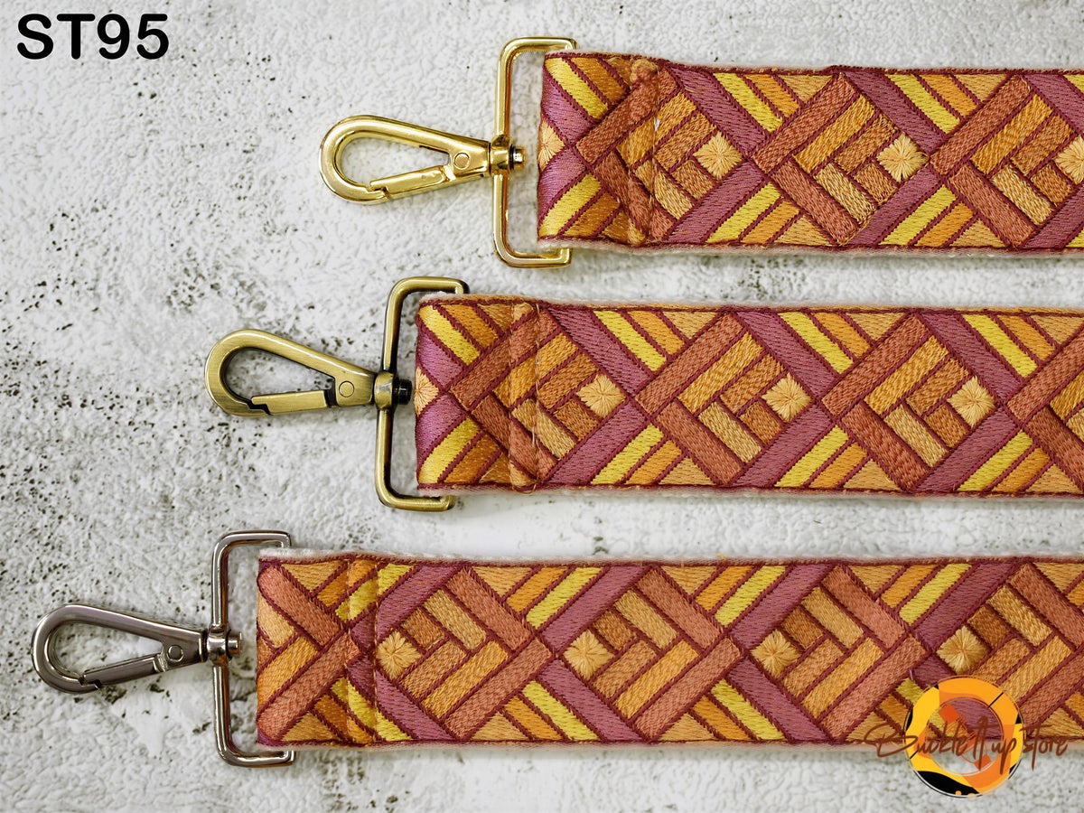 three colorful straps with a geometric pattern, each with a metal clasp and hook.