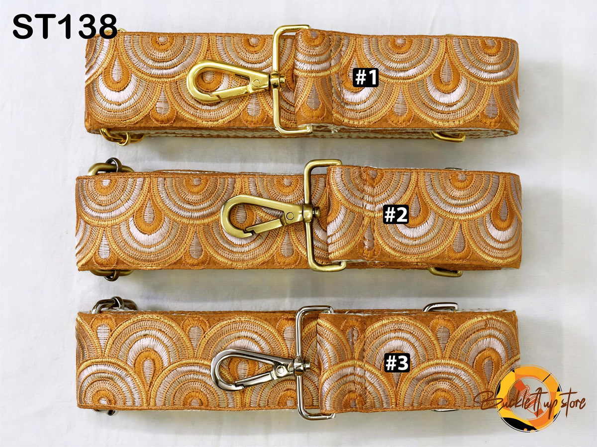 four different straps with a repeating pattern of circles and lines in shades of orange and white. Each strap has a metal clasp and a label indicating the number 1, 2, and 3.
