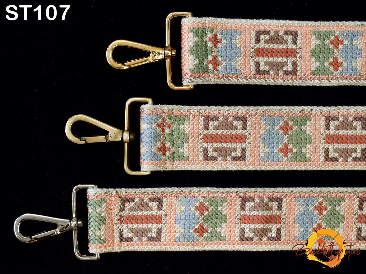 three different straps with metal hooks and colorful embroidered patterns.