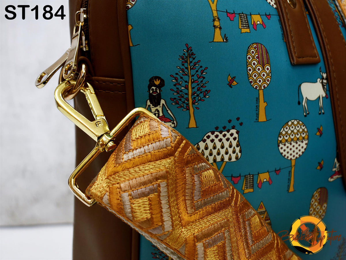 a close-up view of a colorful bag with a pattern of trees, animals, and geometric shapes on a blue background.