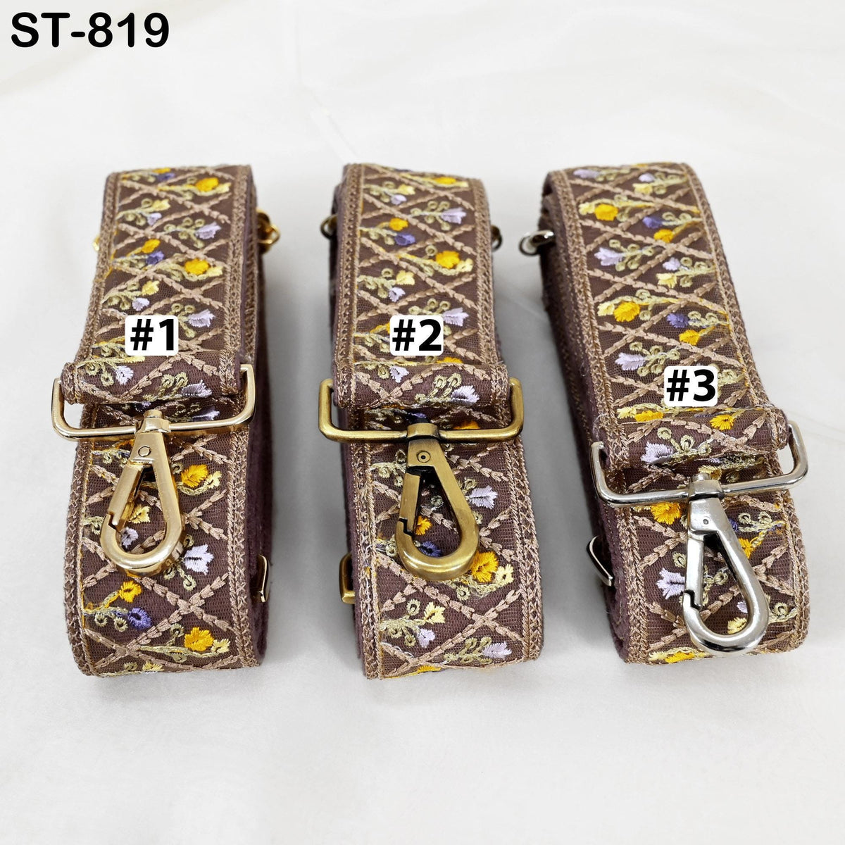 Three brown straps with floral patterns, each with a metal clasp and a label indicating the number.
