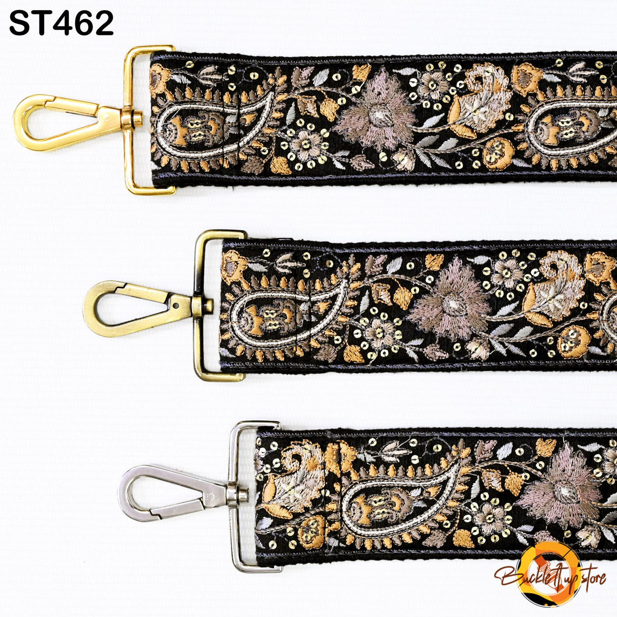 three different straps with intricate floral embroidery patterns in gold and black. The straps appear to be made of a shiny material and have metal hooks or buckles.