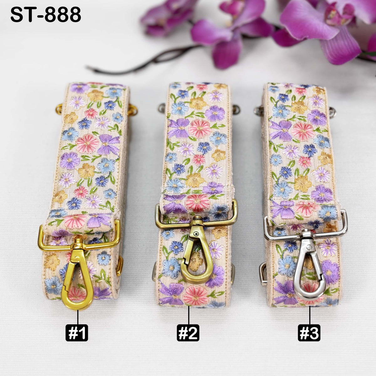 Three floral-patterned straps with metal hardware, each with a different color and design, arranged on a white background.