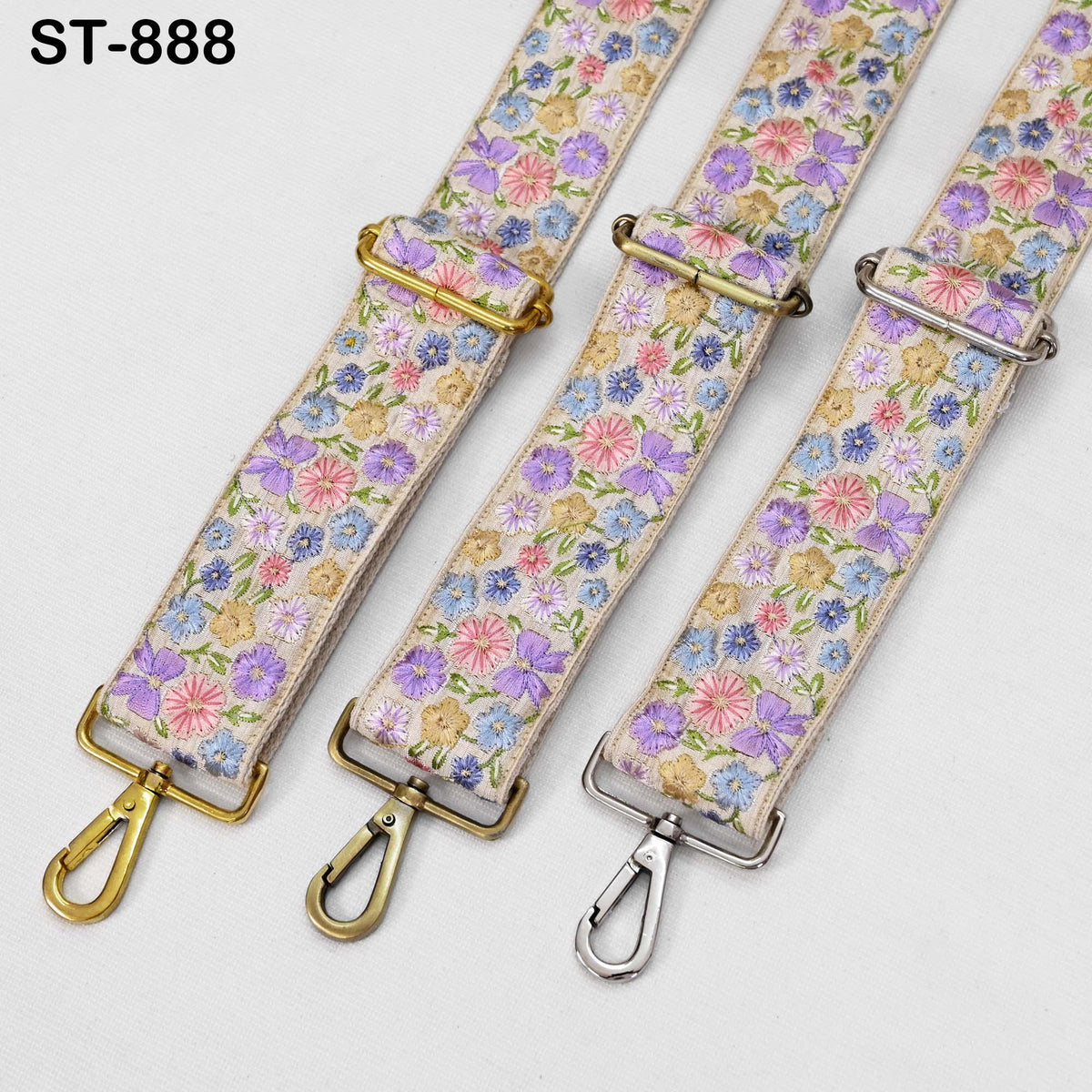three floral-patterned straps with metal buckles, arranged side by side.
