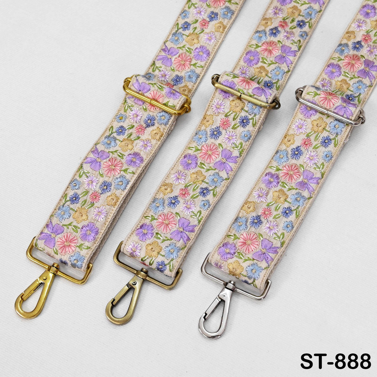 three straps with floral patterns, each with a metal clasp and hook.