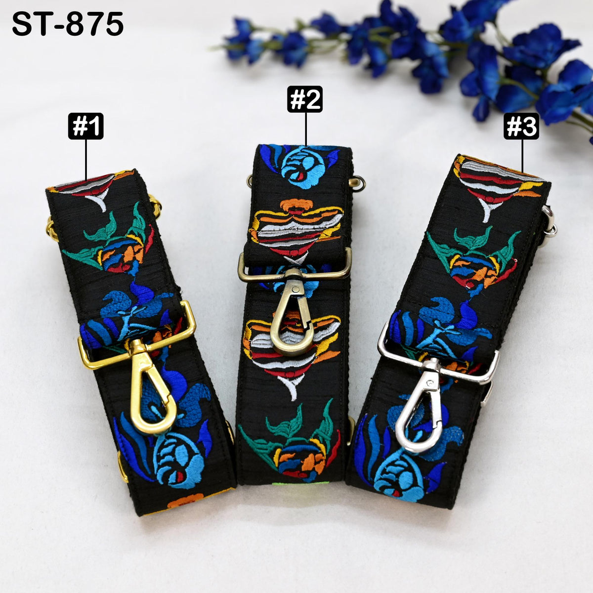 Three colorful straps with floral patterns, each with a metal clasp and hook, are displayed against a white background.