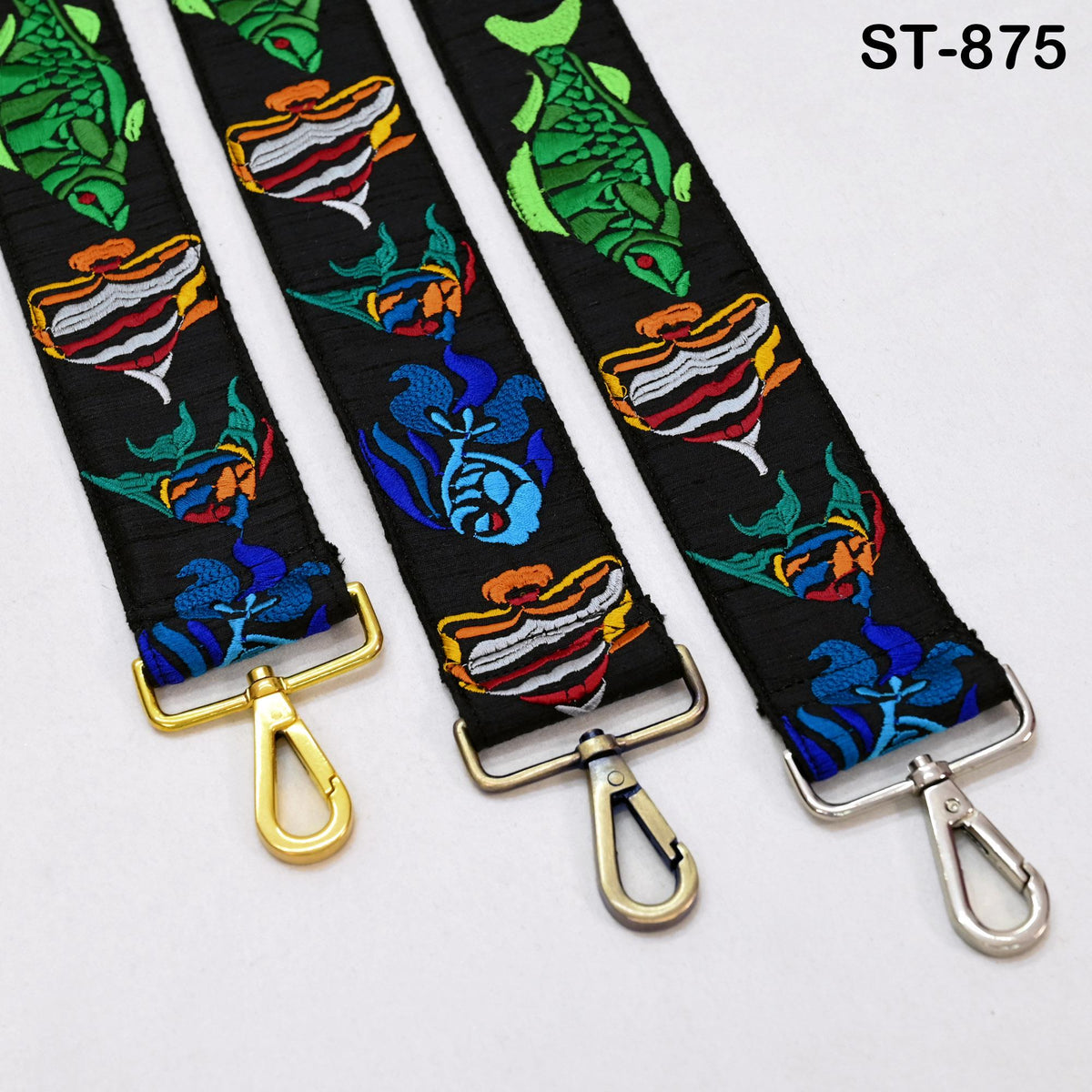 three colorful straps with various designs, including fish and floral patterns, attached to metal loops.