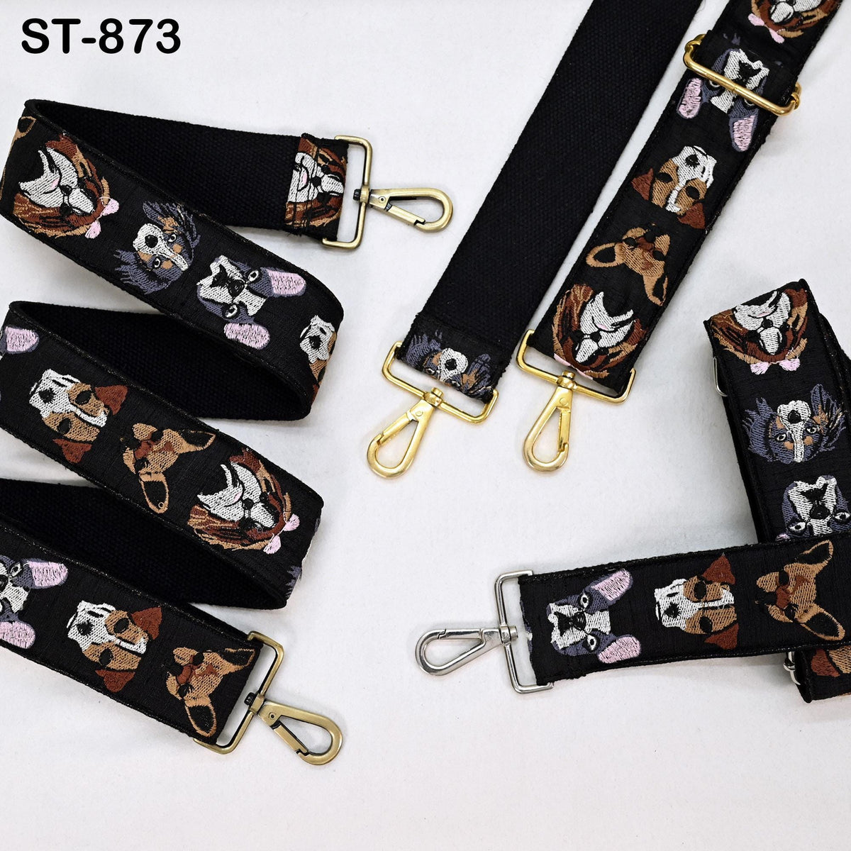 a collection of black straps with various dog-themed embroidery designs, including different breeds of dogs and other animals. The straps appear to be adjustable and designed for use as straps or handles.