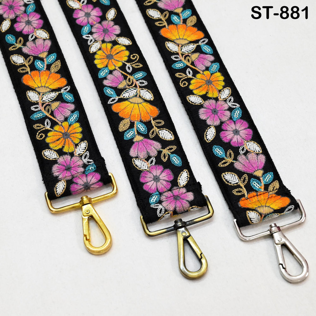 three colorful straps with floral embroidery, each with a gold-colored metal clasp.