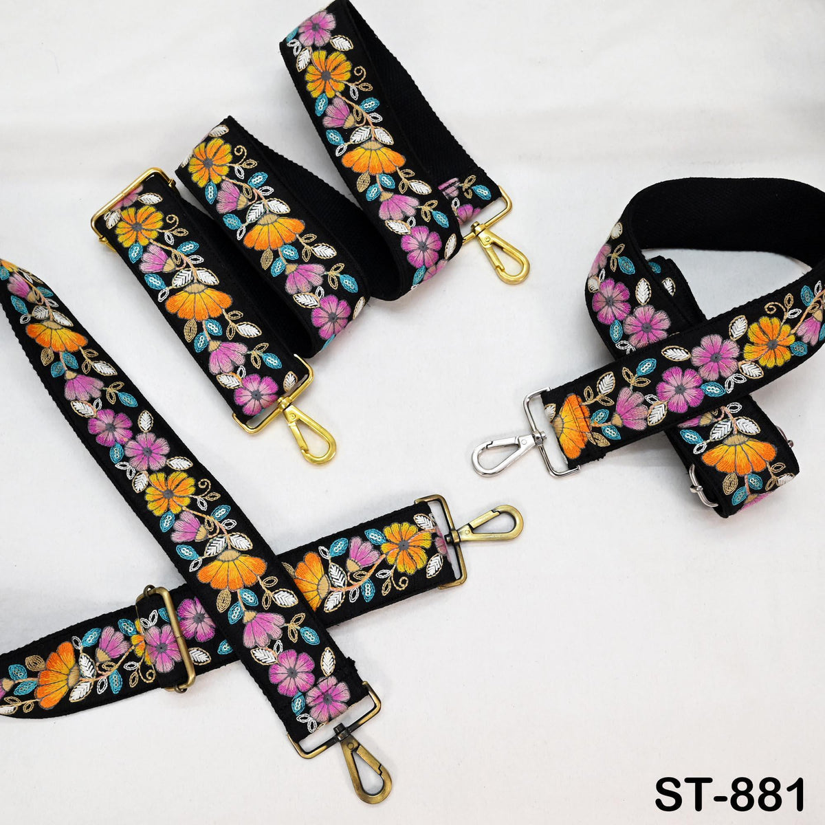 a collection of colorful floral-patterned straps, including straps with gold hardware, arranged on a white background.