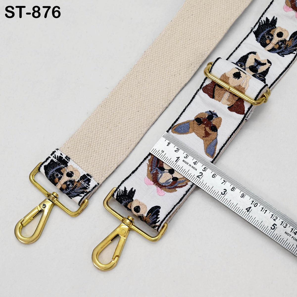 a beige strap with a pattern of dog faces on it, and a ruler is placed next to it, indicating the strap's length.