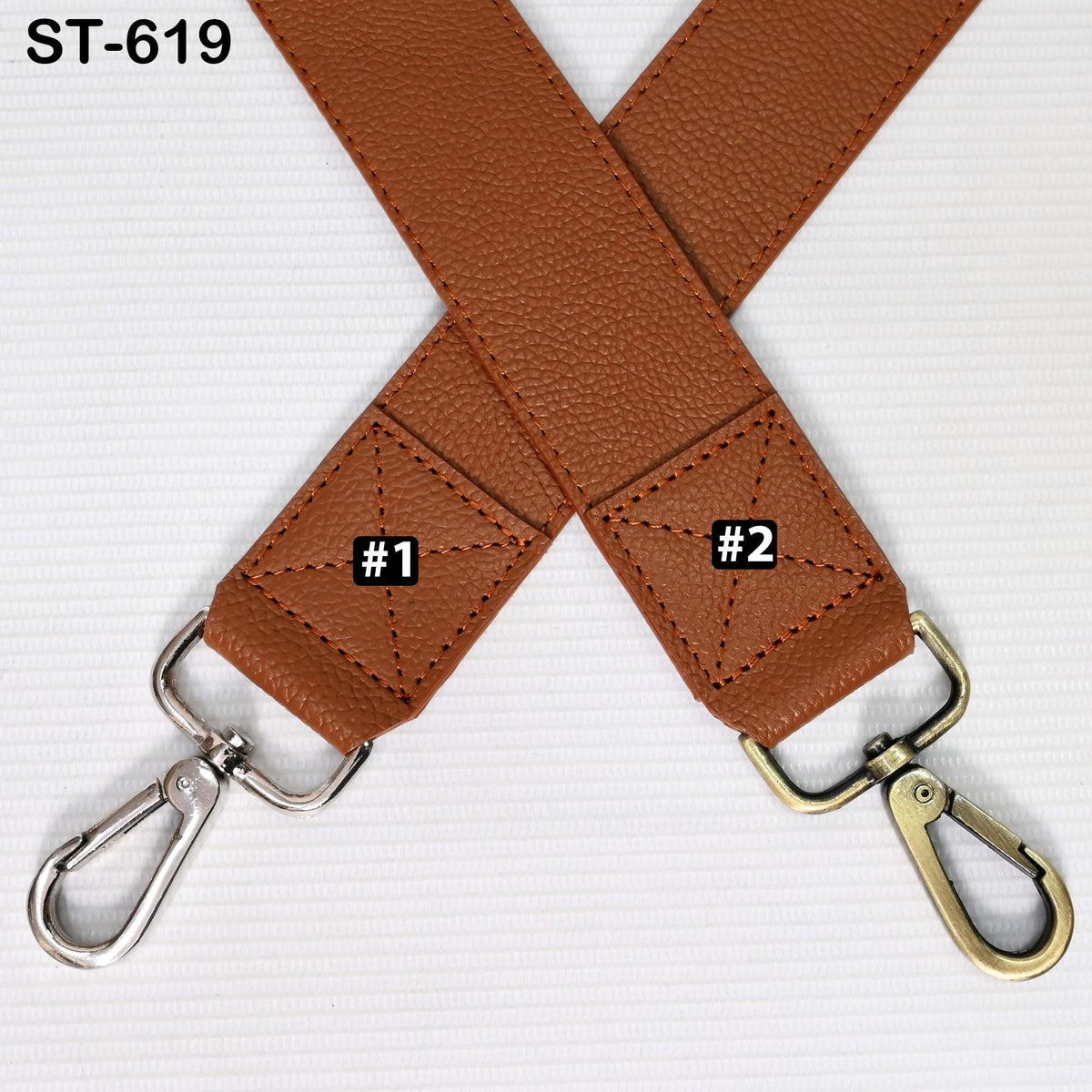 a brown leather strap with two metal hooks attached to it, placed diagonally across each other.