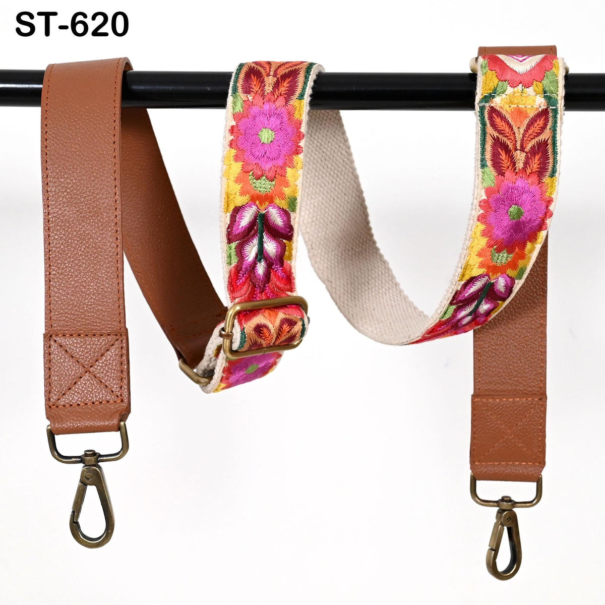 two colorful straps hanging on a black bar. The straps have a floral pattern and appear to be made of leather.