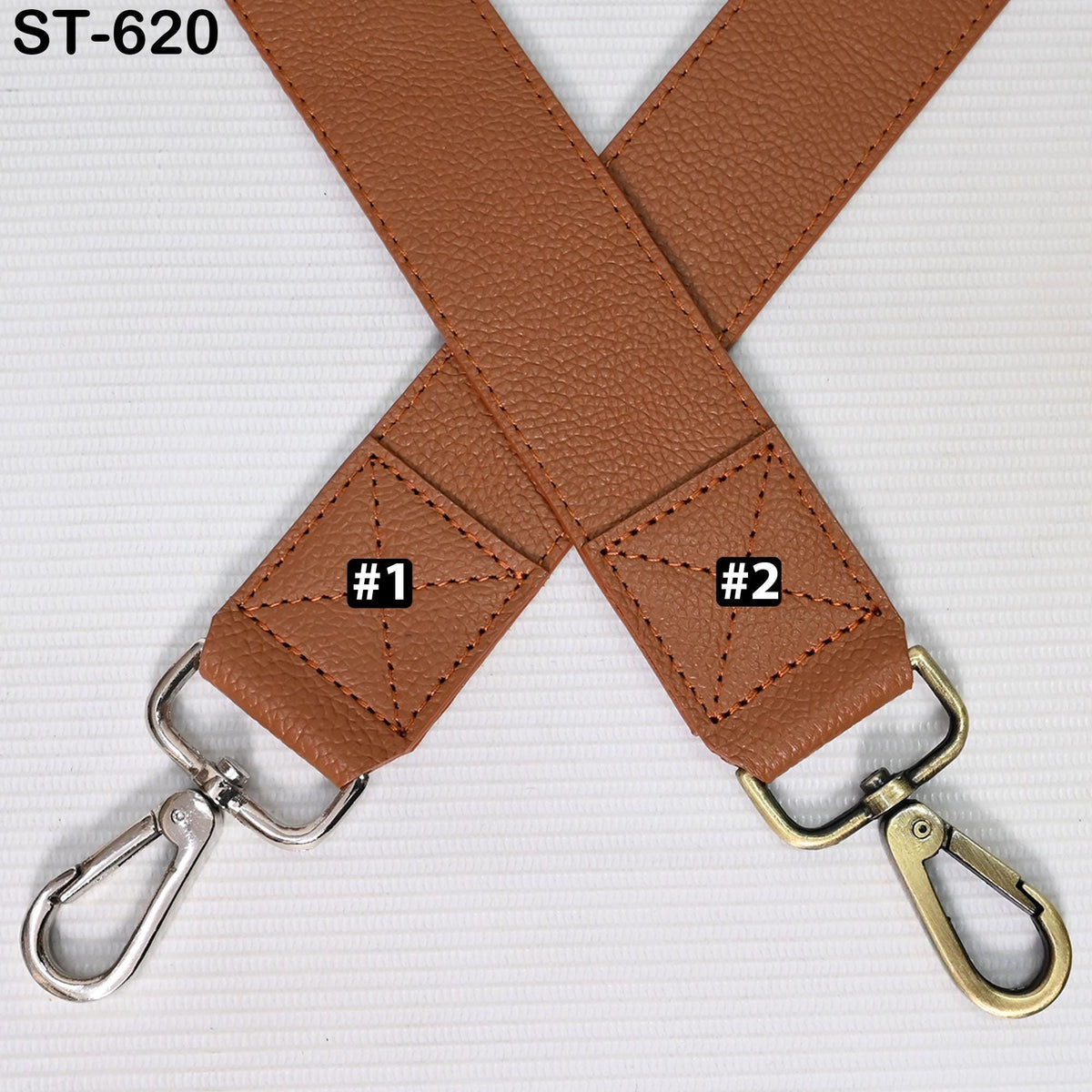 two leather straps, one brown and one silver, crossed over each other with metal hooks attached.