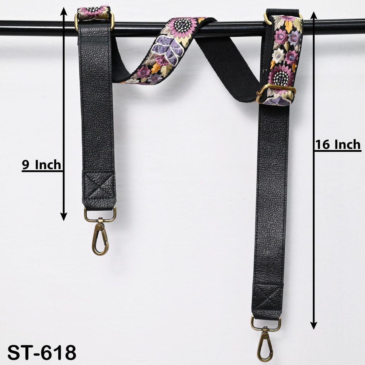 a pair of black leather straps with floral embroidery, hanging on a black rod. The straps are labeled with measurements, indicating that they are 9 inches long and 16 inches in length.